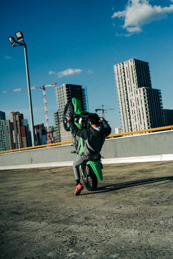 Azza standing a wheelie on the KX450 with Milano towers behind